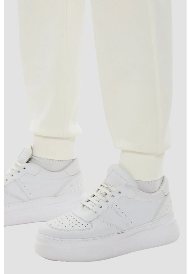 Guess - GUESS Beżowe damskie spodnie dresowe Olympe, Rozmiar S. Kolor: beżowy. Materiał: dresówka