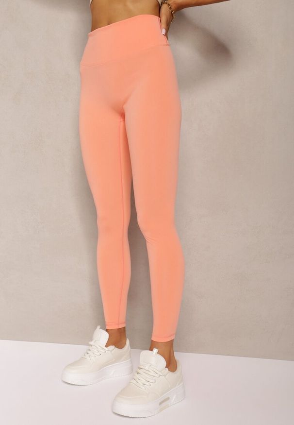 Renee - Pomarańczowe Sportowe Legginsy High Waist Quarefia. Stan: podwyższony. Kolor: pomarańczowy. Materiał: dzianina, materiał. Długość: długie. Styl: sportowy