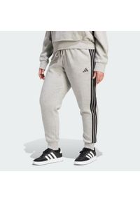 Adidas - Spodnie Essentials 3-Stripes Fleece Slim (Plus Size). Kolekcja: plus size. Kolor: wielokolorowy, czarny, szary. Materiał: polar