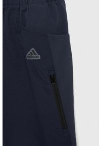 Adidas - adidas spodnie dziecięce U CE DW kolor granatowy gładkie. Kolor: niebieski. Materiał: tkanina, poliester. Wzór: gładki #3