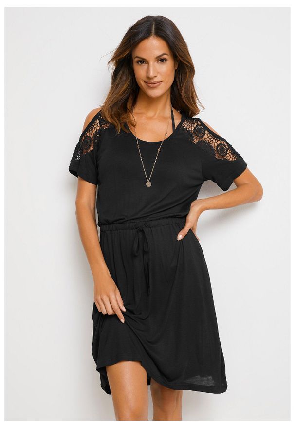 bonprix - Prześwitująca sukienka plażowa. Okazja: na plażę. Kolor: czarny. Materiał: koronka. Wzór: koronka