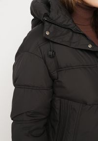 Born2be - Czarna Kurtka Pikowana z Kapturem i Ściągaczami przy Rękawach Hedivra. Okazja: na co dzień, na spacer. Typ kołnierza: kaptur. Kolor: czarny. Materiał: jeans. Długość rękawa: długi rękaw. Długość: długie. Sezon: zima. Styl: klasyczny, casual #6