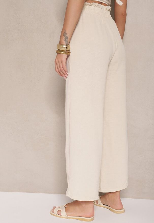 Renee - Beżowe Spodnie z Wiskozą o Szerokim Kroju High Waist z Wiązaniem Ivelwia. Stan: podwyższony. Kolor: beżowy. Materiał: wiskoza. Sezon: lato