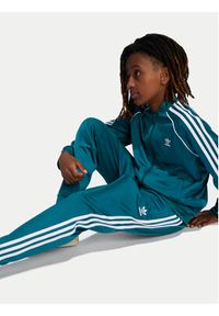 Adidas - adidas Spodnie dresowe adicolor SST IY7463 Turkusowy Regular Fit. Kolor: turkusowy. Materiał: syntetyk