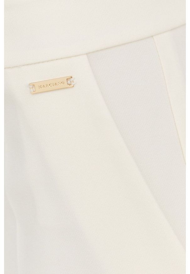Marciano Guess spodnie damskie kolor beżowy proste medium waist. Okazja: na co dzień. Kolor: beżowy. Materiał: tkanina. Styl: casual