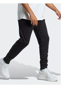Adidas - adidas Spodnie dresowe Essentials French Terry Tapered Cuff Logo Joggers IC0063 Czarny Regular Fit. Kolor: czarny. Materiał: bawełna