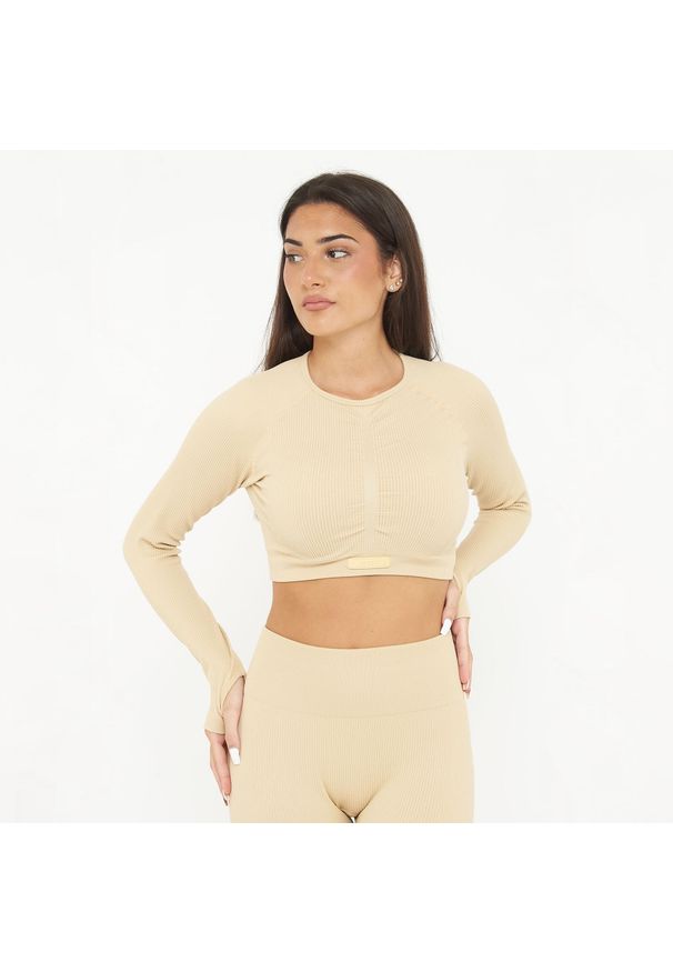 LEGEA - Koszulka Crop Top treningowa IMALA długie rękawy. Kolor: beżowy. Materiał: nylon, elastan. Długość rękawa: długi rękaw. Długość: długie