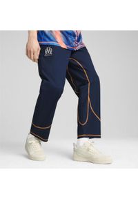 Puma - Męskie spodnie dresowe ftblSTATEMENT Olympique Marsylia PUMA. Kolor: pomarańczowy, niebieski, wielokolorowy, żółty. Materiał: dresówka. Sport: piłka nożna