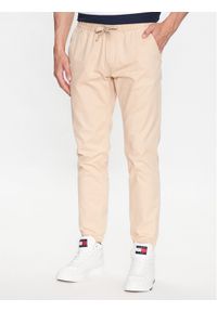 Tommy Jeans Joggery DM0DM16760 Beżowy Slim Fit. Kolor: beżowy. Materiał: bawełna