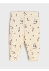 Sinsay - Spodnie z polarem w środku Winnie the Pooh - kremowy. Kolor: kremowy. Materiał: polar