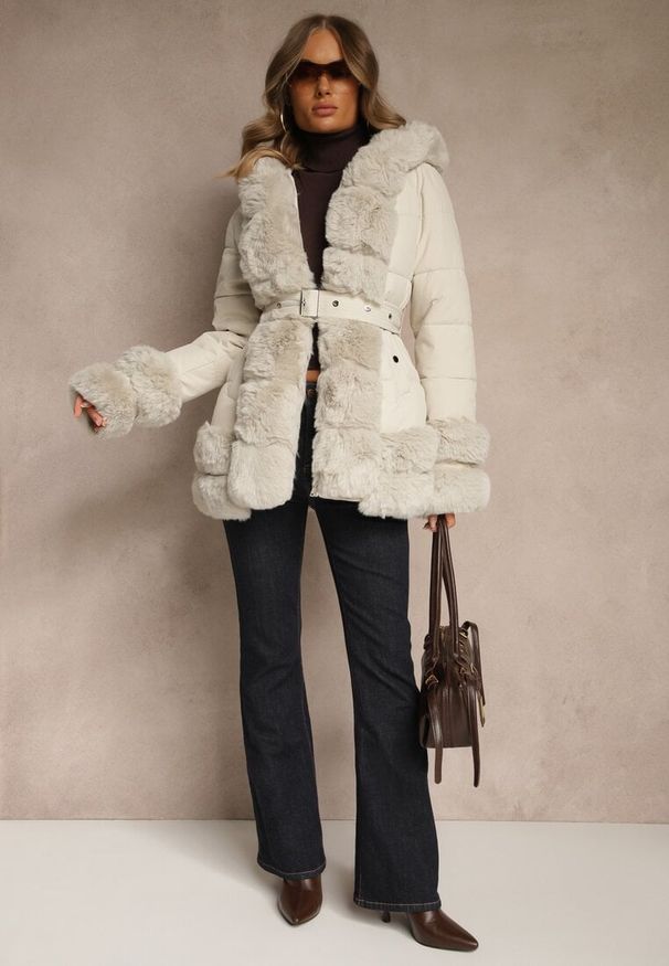 Renee - Jasnobeżowa Kurtka o Taliowanym Kroju z Paskiem Kapturem i Futerkiem Ranalia. Typ kołnierza: golf. Kolor: beżowy. Materiał: futro. Sezon: zima