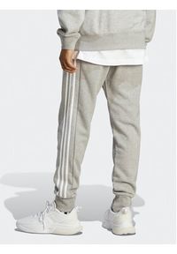 Adidas - adidas Spodnie dresowe Essentials French Terry Tapered Cuff 3-Stripes Joggers IC9407 Szary Regular Fit. Kolor: szary. Materiał: bawełna