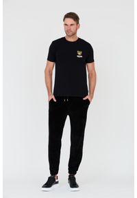 MOSCHINO Czarne męskie welurowe spodnie dresowe, Rozmiar S. Kolor: czarny. Materiał: dresówka, welur