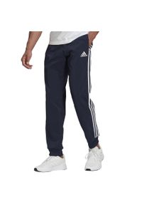 Adidas - Spodnie męskie adidas Essentials Tapered Cuff 3 Stripes. Kolor: biały, wielokolorowy, niebieski. Materiał: polar