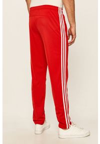 Adidas - adidas - Spodnie. Kolor: czerwony. Materiał: tkanina, poliester. Wzór: aplikacja #3
