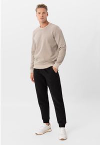 Volcano - Dresowe spodnie N-NICER. Kolor: czarny. Materiał: dresówka. Wzór: napisy #1