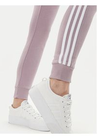 Adidas - adidas Spodnie dresowe Essentials 3-Stripes IR5379 Różowy Slim Fit. Kolor: różowy. Materiał: bawełna #3