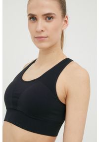 Calvin Klein Performance biustonosz sportowy Seamless kolor czarny gładki. Kolor: czarny. Materiał: skóra, materiał. Rodzaj stanika: wyciągane miseczki. Wzór: gładki. Sport: fitness, taniec #1