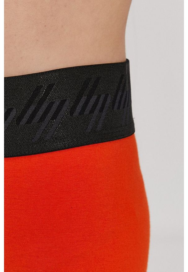 Superdry Legginsy damskie kolor pomarańczowy z nadrukiem. Kolor: pomarańczowy. Materiał: dzianina. Wzór: nadruk