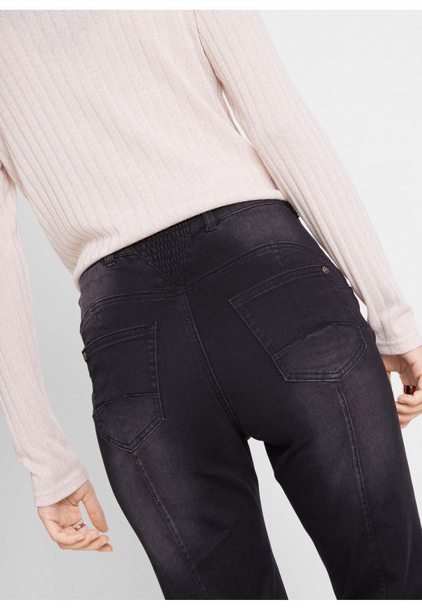 bonprix - Modelujące dżinsy o kroju bootcut, mid waist. Kolor: czarny