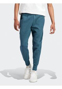 Adidas - adidas Spodnie dresowe IN5100 Turkusowy Regular Fit. Kolor: turkusowy. Materiał: bawełna