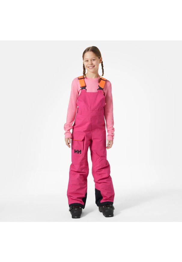 Dziecięce spodnie narciarskie na szelkach Helly Hansen Summit. Kolor: różowy. Sezon: zima. Sport: narciarstwo
