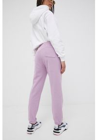 Champion spodnie dresowe damskie kolor fioletowy gładkie. Kolor: fioletowy. Materiał: dresówka. Wzór: gładki