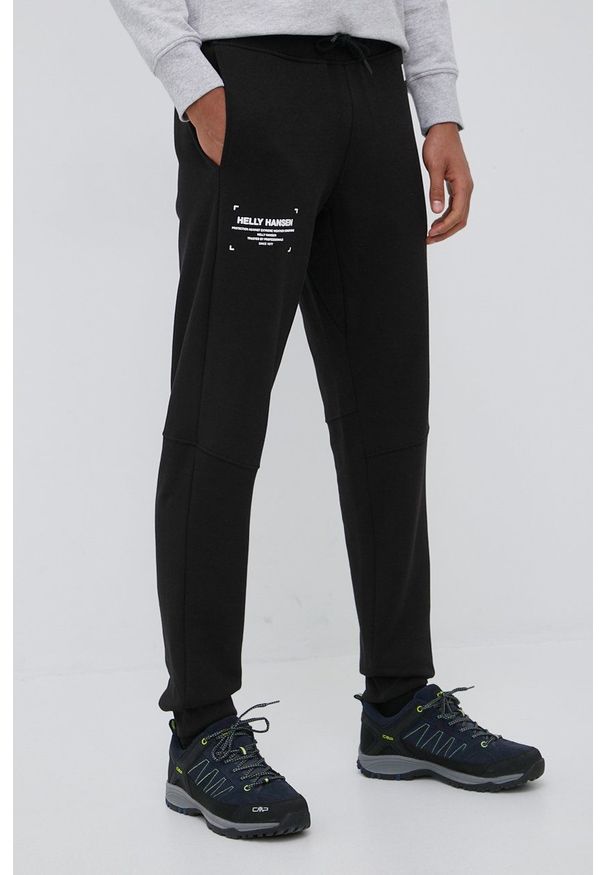 Helly Hansen spodnie dresowe męskie kolor czarny z nadrukiem. Kolor: czarny. Materiał: dresówka. Wzór: nadruk