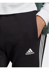 Adidas - adidas Spodnie dresowe Essentials French Terry Tapered Elastic Cuff 3-Stripes Joggers IC0050 Czarny Regular Fit. Kolor: czarny. Materiał: dresówka, bawełna