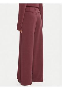 Guess Spodnie dresowe V4YB07 KCAY2 Bordowy Relaxed Fit. Kolor: czerwony. Materiał: syntetyk