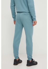Guess spodnie dresowe kolor zielony melanżowe. Kolor: turkusowy. Materiał: dresówka. Wzór: melanż #4