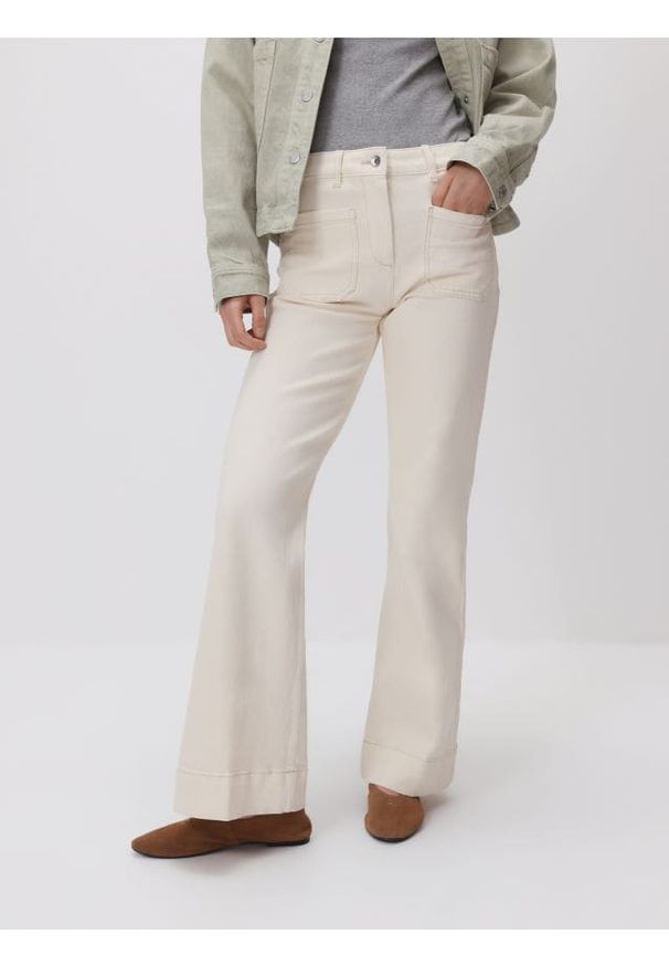 Reserved - Jeansy flare - kremowy. Kolor: kremowy