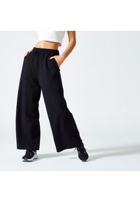 DOMYOS - Spodnie dresowe damskie Nyamba Gym & Pilates 520 Flare. Kolor: czarny. Materiał: elastan, bawełna, materiał. Sport: joga i pilates #1