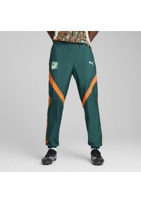 Puma - Męskie spodnie przedmeczowe Wybrzeże Kości Słoniowej 2025 PUMA. Kolor: zielony, pomarańczowy, wielokolorowy, żółty. Materiał: dresówka. Sport: piłka nożna