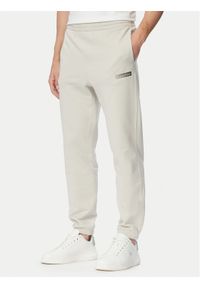 Calvin Klein Spodnie dresowe LV04LG212G Beżowy Regular Fit. Kolor: beżowy. Materiał: bawełna #1