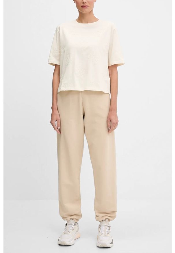 Guess - GUESS Beżowe damskie spodnie dresowe Primula, Rozmiar S. Kolor: beżowy. Materiał: dresówka