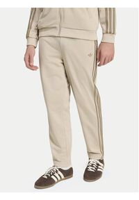 Adidas - adidas Spodnie dresowe Firebird HZ6652 Beżowy jasny Regular Fit. Kolor: beżowy. Materiał: syntetyk #2