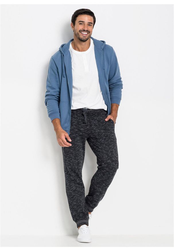 bonprix - Melanżowe spodnie sportowe ze ściągaczem. Kolor: czarny. Wzór: melanż, prążki. Styl: sportowy