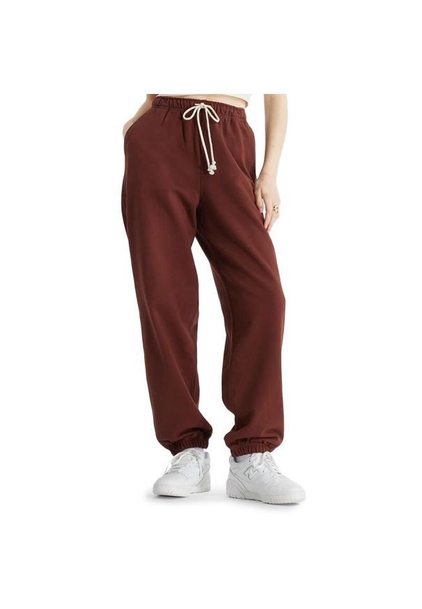 Spodnie New Balance WP41513ROK - brązowe. Kolor: brązowy. Materiał: dresówka, bawełna, poliester