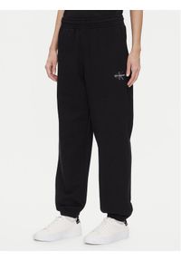 Calvin Klein Jeans Spodnie dresowe Monologo LV047B235G Czarny Regular Fit. Kolor: czarny. Materiał: bawełna