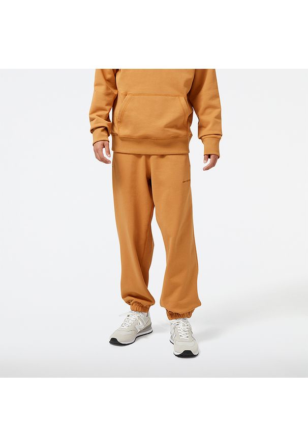 Spodnie męskie New Balance MP23551TOB – pomarańczowe. Kolor: pomarańczowy. Materiał: materiał, bawełna, dresówka