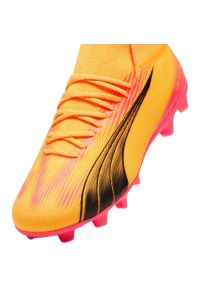 Buty piłkarskie Puma Ultra Pro FG/AG Jr 107769 03 pomarańczowe. Kolor: pomarańczowy. Materiał: syntetyk. Szerokość cholewki: normalna. Sport: piłka nożna