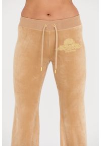 Juicy Couture - JUICY COUTURE Beżowe spodnie Arched Metallic Layla. Kolor: beżowy #2