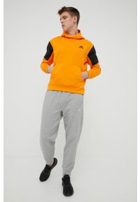adidas Performance bluza HE9819 męska kolor pomarańczowy z kapturem z nadrukiem. Typ kołnierza: kaptur. Kolor: pomarańczowy. Materiał: poliester, bawełna. Wzór: nadruk