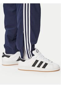 Adidas - adidas Spodnie dresowe Firebird Woven KE1370 Granatowy Regular Fit. Kolor: niebieski. Materiał: syntetyk #3