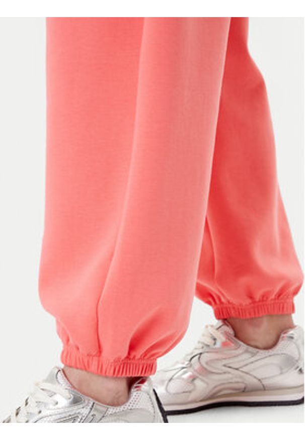 Adidas - adidas Spodnie dresowe ALL SZN Soft Lux lKD9773 Koralowy Loose Fit. Kolor: pomarańczowy. Materiał: syntetyk