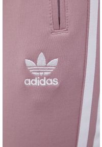 adidas Originals spodnie damskie kolor różowy gładkie. Kolor: różowy. Materiał: materiał, dzianina. Wzór: gładki