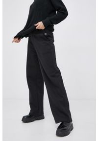Tommy Jeans Spodnie damskie kolor czarny gładkie. Kolor: czarny. Materiał: dzianina. Wzór: gładki