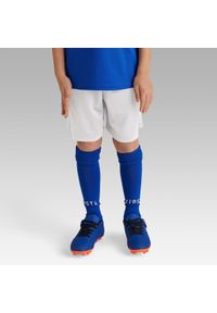 KIPSTA - Spodenki piłkarskie dla dzieci Kipsta Essential Club. Kolor: biały. Materiał: poliester, materiał. Styl: sportowy