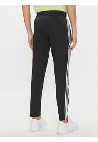 Adidas - adidas Spodnie dresowe Essentials Single Jersey Tapered Open Hem 3-Stripes Joggers IC0044 Czarny Regular Fit. Kolor: czarny. Materiał: bawełna